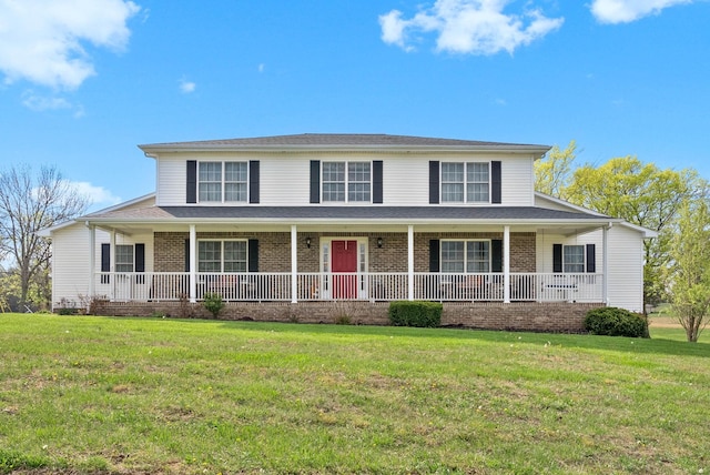 view of front of house featuring covered porch, a front lawn, and brick siding