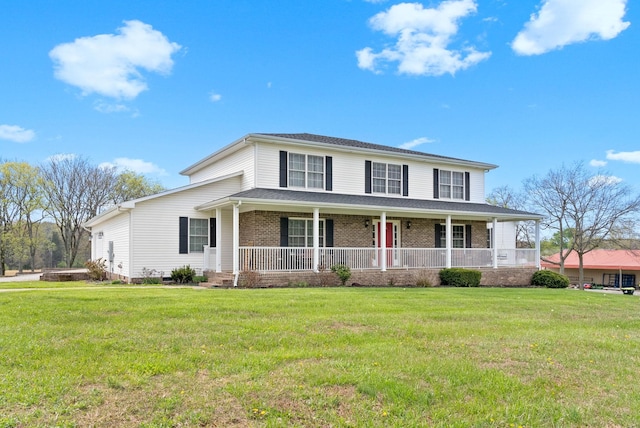 view of front of property featuring brick siding, a front yard, and a porch