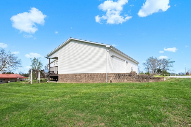 view of property exterior featuring brick siding and a lawn