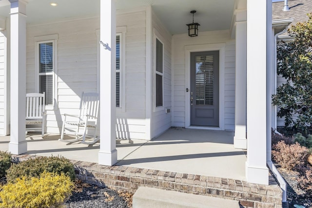 view of exterior entry with covered porch