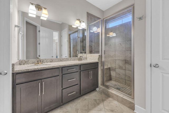 full bathroom with a sink, a shower stall, marble finish floor, and double vanity