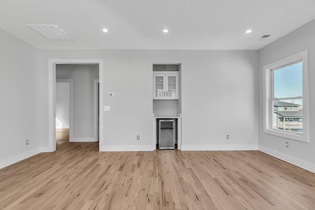 6376B Ivy St, Nashville, TN 37209 - unfurnished living room with baseboards, a dry bar, light wood-type flooring, wine cooler, and recessed lighting