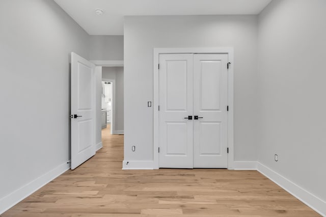6376D Ivy St, Nashville, TN 37209 - unfurnished bedroom featuring light wood-style floors, a closet, and baseboards