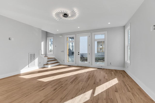 6376D Ivy St, Nashville, TN 37209 - unfurnished living room with baseboards, recessed lighting, light wood-style flooring, stairs, and visible vents