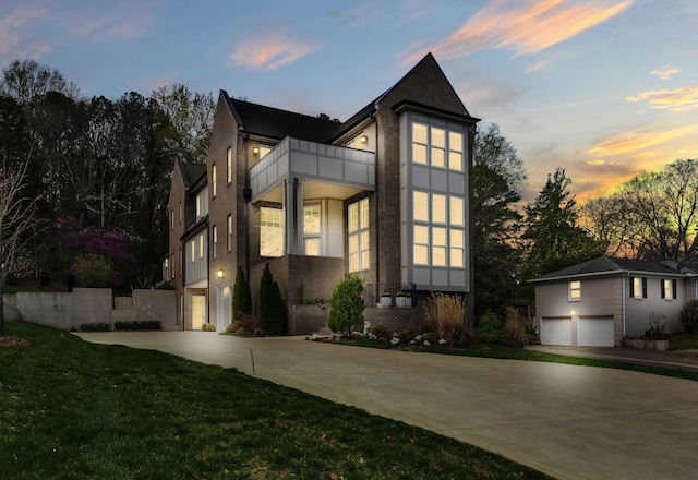 113 Cheekwood Ter, Nashville, TN 37205 - modern home with concrete driveway, a balcony, a yard, brick siding, and a garage