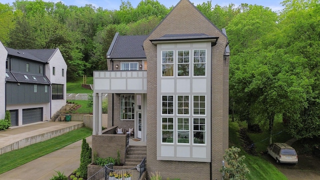 113 Cheekwood Ter, Nashville, TN 37205 - exterior space with concrete driveway, a forest view, stairs, and an attached garage