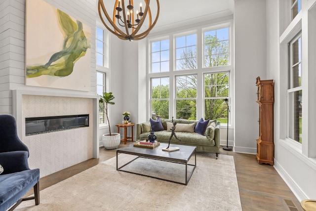 113 Cheekwood Ter, Nashville, TN 37205 - sitting room featuring a tile fireplace, an inviting chandelier, a wealth of natural light, and baseboards