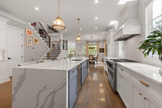 113 Cheekwood Ter, Nashville, TN 37205 - kitchen with a spacious island, custom range hood, appliances with stainless steel finishes, white cabinets, and a sink