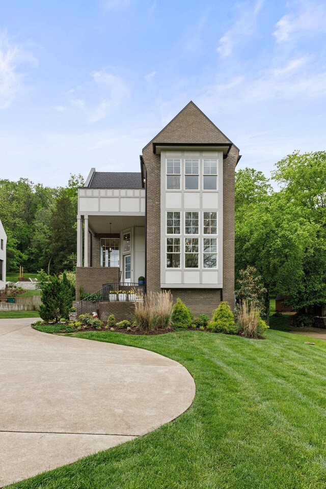 113 Cheekwood Ter, Nashville, TN 37205 - back of property with brick siding, a porch, and a lawn
