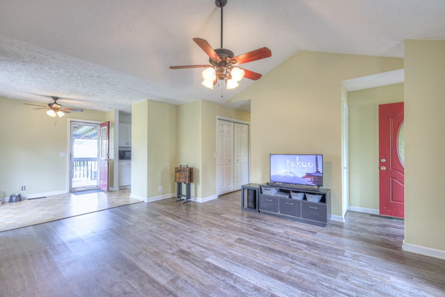 109 Spring Valley Ct, Cross Plains, TN 37049 - unfurnished living room featuring lofted ceiling, wood finished floors, a ceiling fan, and baseboards