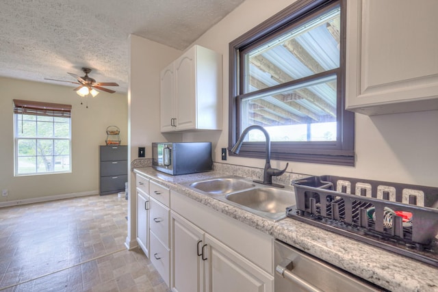 109 Spring Valley Ct, Cross Plains, TN 37049 - kitchen featuring white cabinets, appliances with stainless steel finishes, a sink, and a textured ceiling