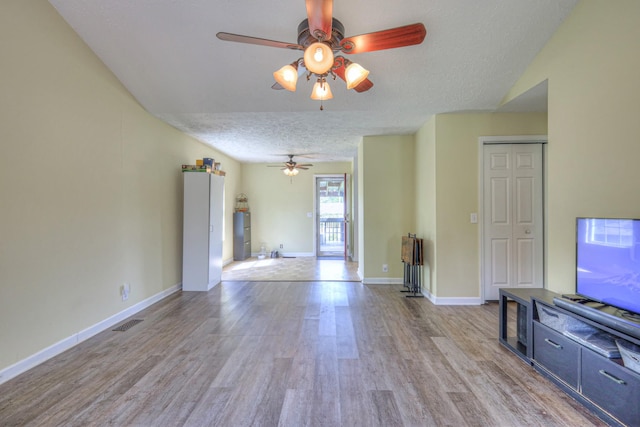 109 Spring Valley Ct, Cross Plains, TN 37049 - unfurnished living room featuring a textured ceiling, visible vents, baseboards, a ceiling fan, and wood finished floors