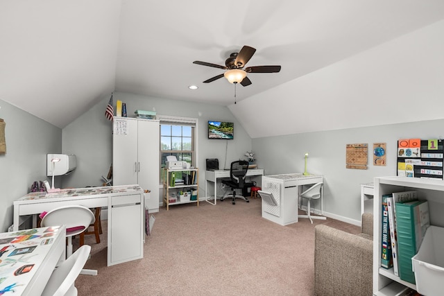 carpeted office space with baseboards, a ceiling fan, and vaulted ceiling