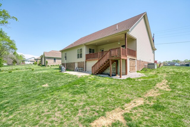 back of property featuring stairway, cooling unit, a patio area, a wooden deck, and a yard