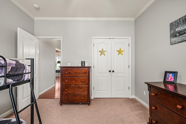 bedroom featuring crown molding, baseboards, and light carpet