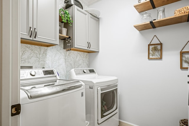 laundry room with cabinet space and washing machine and clothes dryer