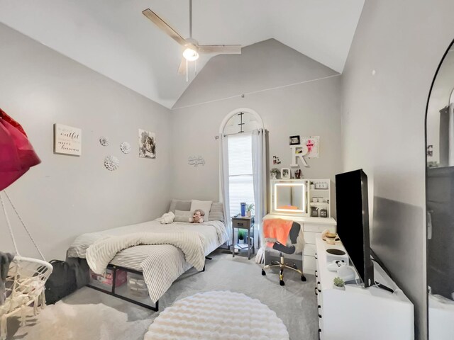 carpeted bedroom featuring high vaulted ceiling and a ceiling fan