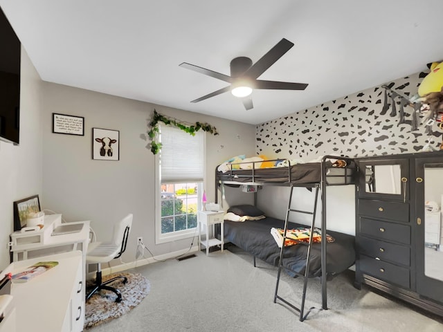 carpeted bedroom featuring baseboards and a ceiling fan