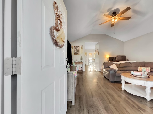 interior space featuring lofted ceiling, wood finished floors, and ceiling fan