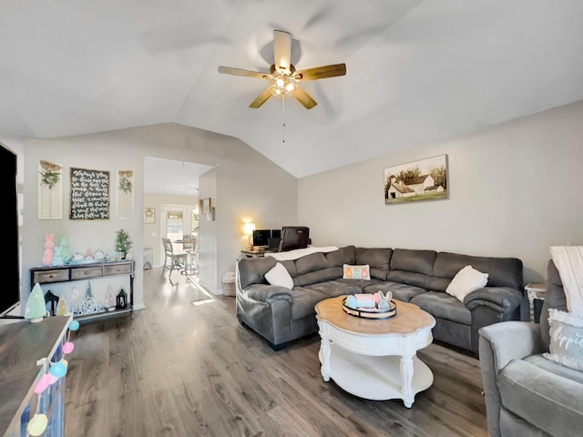 living area featuring ceiling fan, lofted ceiling, and wood finished floors