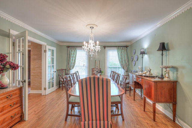 1143 Carnton Ln, Franklin, TN 37064 - dining area with light wood-style flooring, crown molding, and a notable chandelier