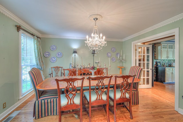 1143 Carnton Ln, Franklin, TN 37064 - dining room with a notable chandelier, baseboards, ornamental molding, light wood-style flooring, and visible vents