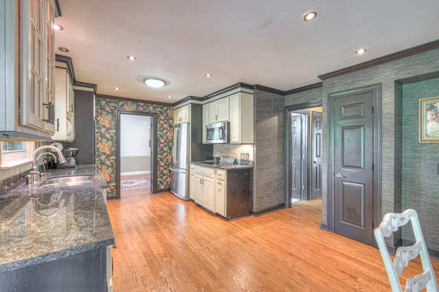 1143 Carnton Ln, Franklin, TN 37064 - kitchen featuring ornamental molding, a sink, stainless steel appliances, wallpapered walls, and light wood finished floors