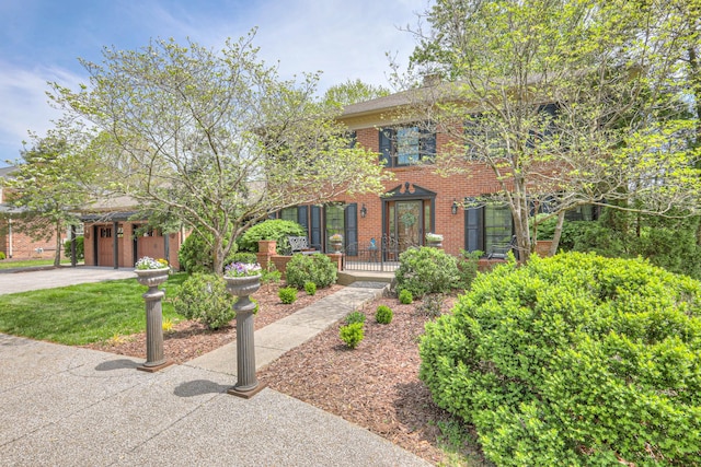 1143 Carnton Ln, Franklin, TN 37064 - colonial house featuring driveway, a garage, and brick siding