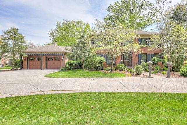 1143 Carnton Ln, Franklin, TN 37064 - view of front of house featuring a garage, a front yard, brick siding, and driveway