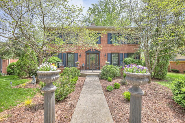 1143 Carnton Ln, Franklin, TN 37064 - colonial home featuring a front yard, brick siding, and a chimney