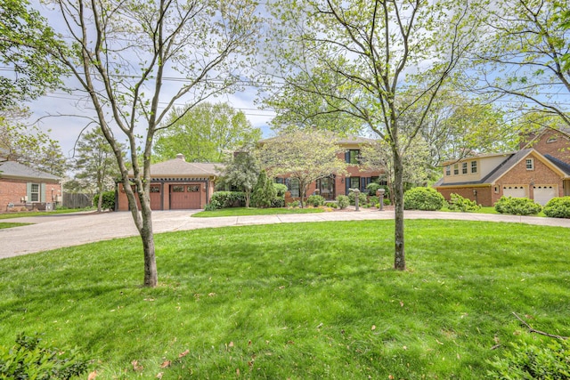 1143 Carnton Ln, Franklin, TN 37064 - view of front of property with brick siding, an attached garage, a front lawn, and concrete driveway