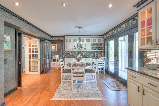 1143 Carnton Ln, Franklin, TN 37064 - dining room with a chandelier, french doors, ornamental molding, and light wood-style flooring