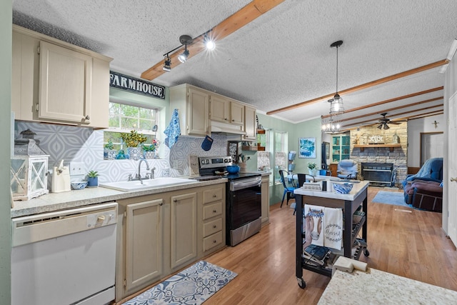 kitchen with a textured ceiling, stainless steel range with electric stovetop, a sink, white dishwasher, and backsplash