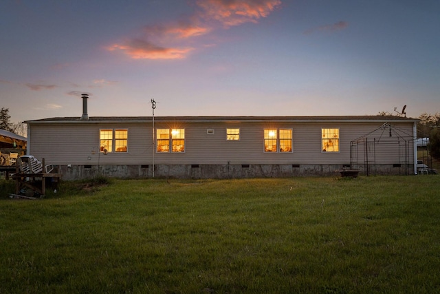 back of property featuring a yard and crawl space