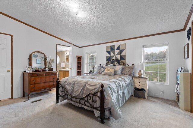 bedroom featuring a textured ceiling, light colored carpet, and ornamental molding