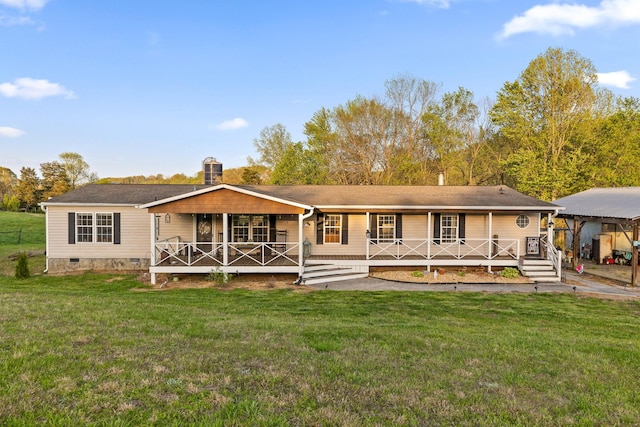 rear view of house with crawl space, covered porch, and a lawn