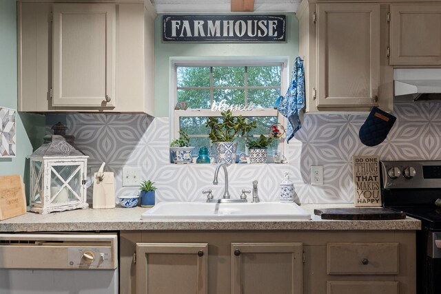 kitchen with dishwashing machine, tasteful backsplash, under cabinet range hood, light countertops, and a sink