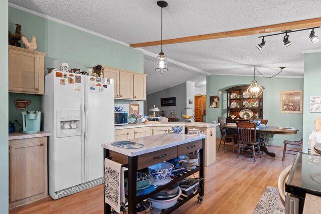 kitchen with white fridge with ice dispenser, light countertops, a peninsula, a textured ceiling, and stainless steel microwave