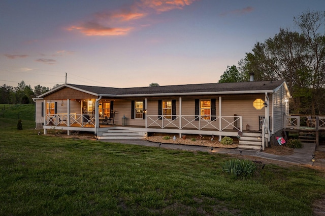 rear view of house with a yard and covered porch