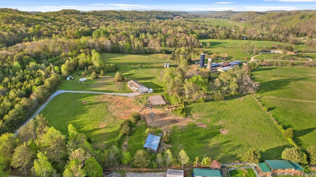drone / aerial view featuring a wooded view and a rural view