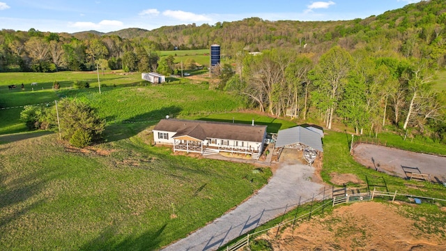 bird's eye view with a mountain view, a view of trees, and a rural view