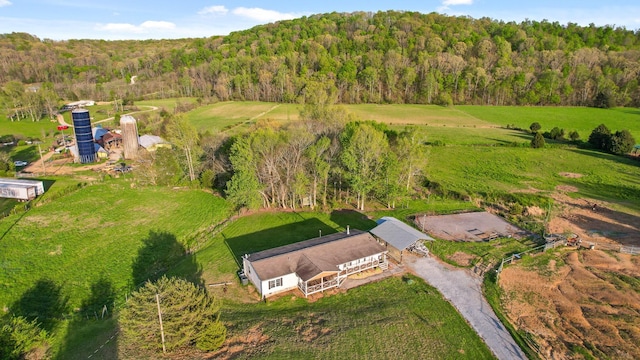 drone / aerial view featuring a wooded view