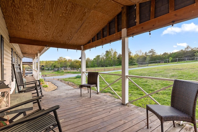 wooden terrace with fence and a lawn