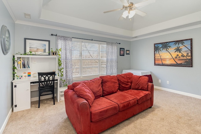 living room featuring a tray ceiling, light colored carpet, baseboards, and ceiling fan