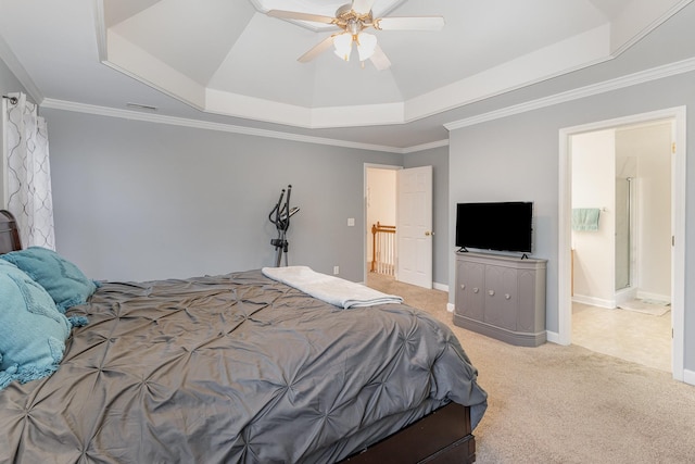 carpeted bedroom with a tray ceiling, crown molding, baseboards, and a ceiling fan