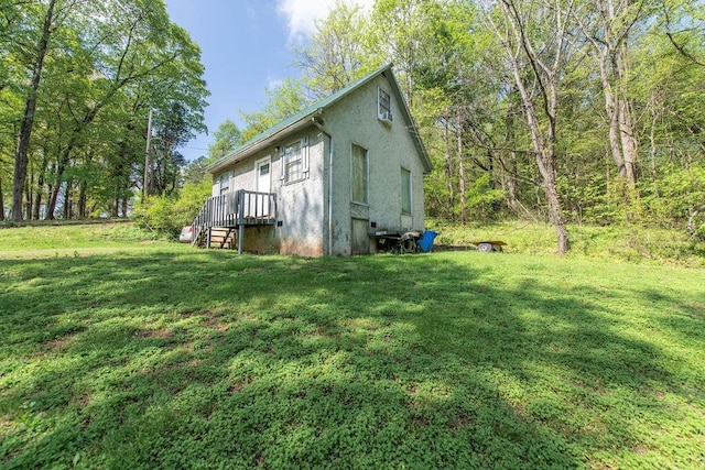 176 Water Ln NW, Charleston, TN 37310 - view of home's exterior with stucco siding and a lawn