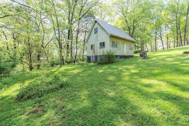 176 Water Ln NW, Charleston, TN 37310 - view of property exterior featuring metal roof and a lawn