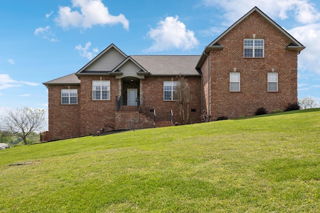 view of front of house featuring brick siding and a front yard