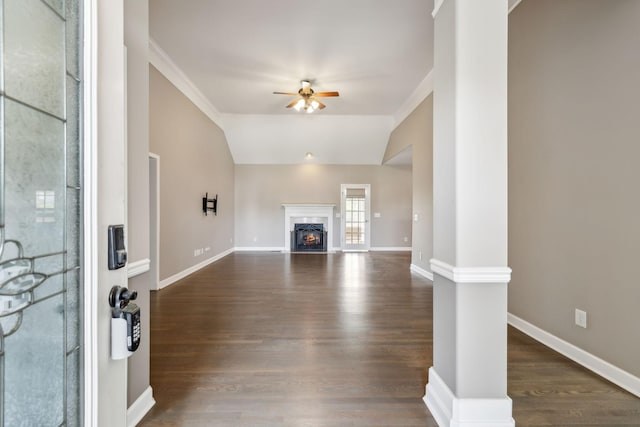 unfurnished living room with a fireplace, dark wood-type flooring, baseboards, and ceiling fan
