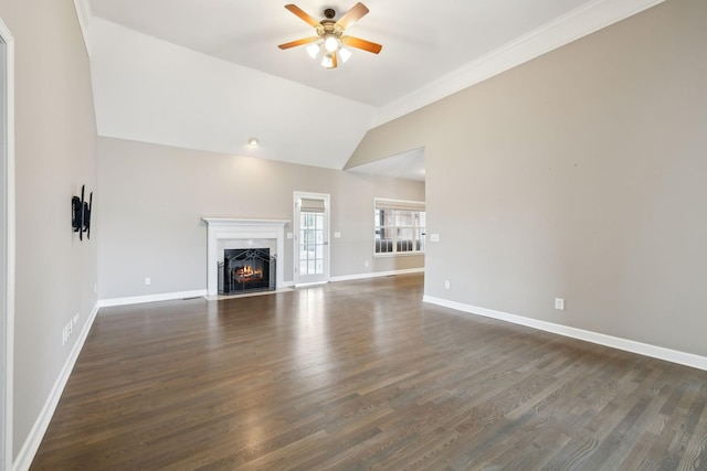 unfurnished living room with a fireplace with flush hearth, dark wood-style floors, vaulted ceiling, baseboards, and ceiling fan